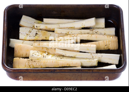 prepared parsnips in a roasting tin isolated Stock Photo