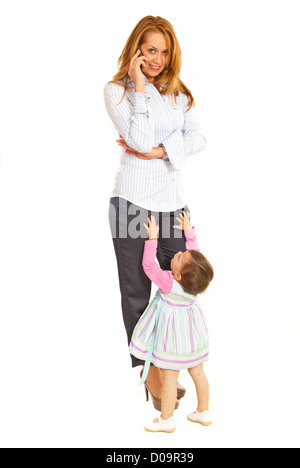 Busy business woman talking by phone mobile and her child girl want to mommy isolated on white background Stock Photo