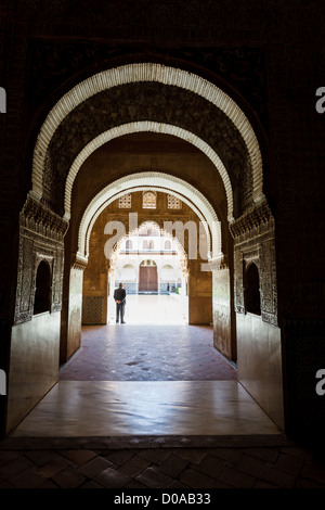 Sunlight and shadows in long series of arches in passageway leading to courtyard in Alhambra Stock Photo