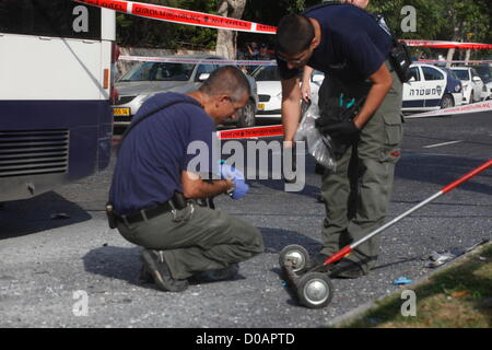 Israeli police forensic experts inspect the scene of an explosion in a bus that was targeted in a bombing attack in Tel Aviv on November 21, 2012 carried out by an Israeli citizen of Arab descent, who remotely detonated an explosive device, which he had hid on the bus in advance. Stock Photo