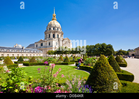 Person looking at the flowers in the gardens of the Eglise du Dome Les Invalides napoleons tomb Paris France EU Europe Stock Photo