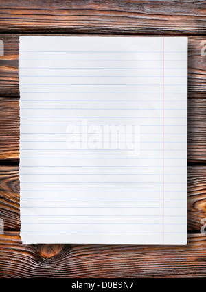 Lined paper on a dark wooden table Stock Photo