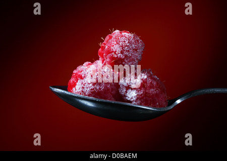 Color photo of pile of red rasberry on metal spoon Stock Photo