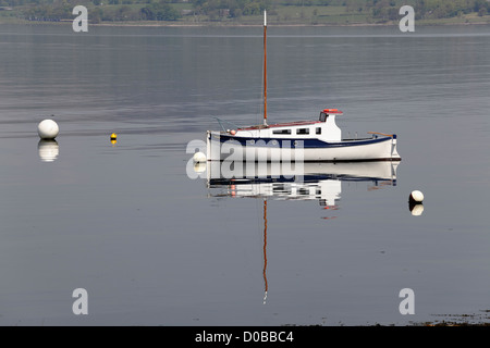 A small sailing boat moored in the Firth of Clyde at Port Glasgow in Inverclyde on the West Coast of Scotland, UK Stock Photo