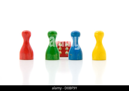 Four colored pawns with red dice, isolated on white background Stock Photo