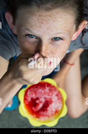 Girl enjoys shaved ice treat. Stock Photo