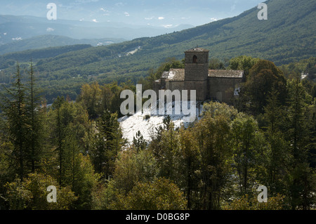 A view from the tiny hilltop village of Gigors of the Romanesque St Peter’s Church and the mountainous landscape of the Vercors. La Drôme, France. Stock Photo