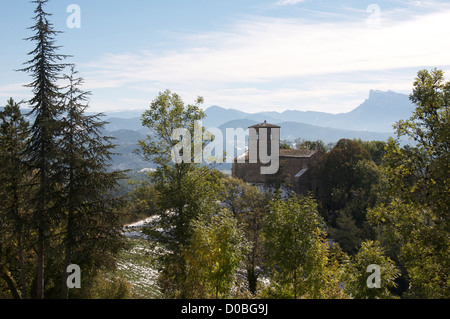 A view from the tiny hilltop village of Gigors of the Romanesque St Peter’s Church and the mountainous landscape of the Vercors. La Drôme, France. Stock Photo