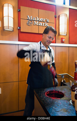 Man Dipping his Maker's Mark Bourbon Bottle in Wax at the Maker's Mark Distillery in Loretto, Kentucky Stock Photo
