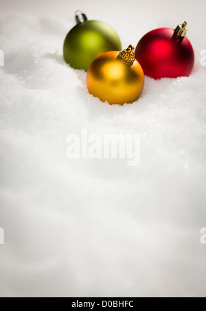 Beautiful Various Colored Christmas Ornaments on Snow Flakes Room For Your Own Text. Stock Photo