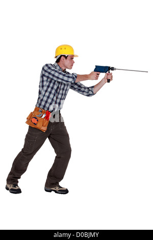 Man using drill with long bit Stock Photo