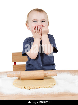 young child making cookies on small wooden desk Stock Photo
