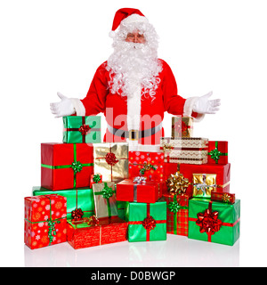 Santa Claus or Father Christmas standing with a large collection of gift wrapped presents, isolated on a white background. Stock Photo