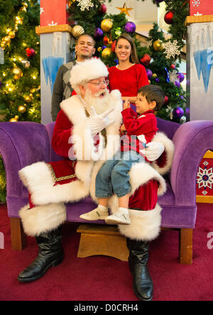 Nov. 21, 2012 - Garden City, New York, U.S.  - Santa Claus gets a Christmas holiday visit from PATRICK HERR, 3 1/2, from Hempstead, at Roosevelt Field shopping mall in Long Island. Patrick's parents JULIANA CARREON and ISMAEL CARREON took him to visit the jolly man. Stock Photo