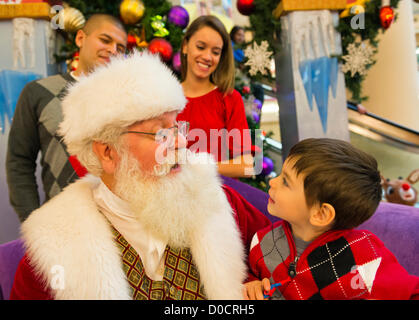 Nov. 21, 2012 - Garden City, New York, U.S - Santa Claus gets a Christmas holiday visit from PATRICK HERR, 3 1/2, from Hempstead, at Roosevelt Field shopping mall in Long Island. Patrick's parents JULIANA CARREON and ISMAEL CARREON took him to visit the jolly man. Stock Photo