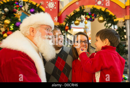 Nov. 21, 2012 - Garden City, New York, U.S. - Santa Claus gets a Christmas holiday visit from PATRICK HERR, 3 1/2, from Hempstead, at Roosevelt Field shopping mall in Long Island. Patrick's parents JULIANA CARREON and ISMAEL CARREON took him to visit the jolly man. Stock Photo