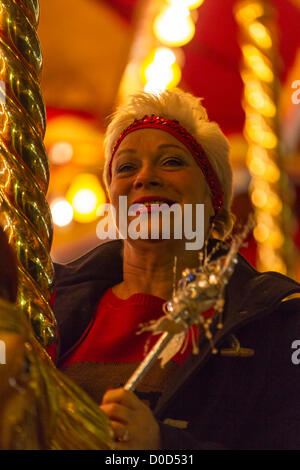 2012-11-22. Abington Street, Northampton. UK . Denise Welch Rides the Carousel before turning on the towns Christmas lights this evening. Stock Photo