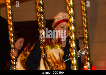 2012-11-22. Abington Street, Northampton. UK . Denise Welch Rides the Carousel before turning on the towns Christmas lights this evening. Stock Photo