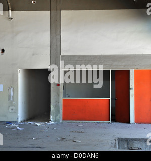Empty room concrete wall and dark hallway in abandoned factory interior. Stock Photo