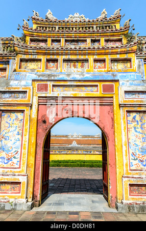 HUE, Vietnam - A painted gate at the Imperial City in Hue, Vietnam. A self-enclosed and fortified palace, the complex includes the Purple Forbidden City, which was the inner sanctum of the imperial household, as well as temples, courtyards, gardens, and other buildings. Much of the Imperial City was damaged or destroyed during the Vietnam War. It is now designated as a UNESCO World Heritage site. This gate was an entrance to the Dien Tho Residence. Constructed in 1804, this compound was was the Queen Mother's or Emperor's Grandmother's living quarters. Stock Photo