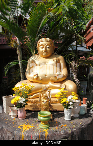 Golden Buddha statue in the garden of the Wat Phra Singha temple, Chiang Rai, Thailand, Asia Stock Photo