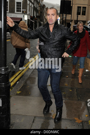 Louie Spence gives snappers an impromptu pole dance, while out and about in Covent Garden! London, England - 26.10.10 Stock Photo