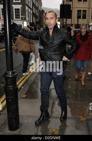 Louie Spence gives snappers an impromptu pole dance, while out and about in Covent Garden! London, England - 26.10.10 :Will Stock Photo