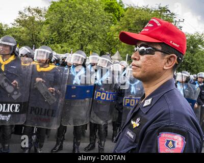 Nov. 23, 2012 - Bangkok, Thailand - A Thai police supervisor watches officers prepare for expected mass protests in Bangkok Friday. Thai authorities have imposed the Internal Security Act (ISA), that enables police to call on the army if needed to keep order, and placed thousands of riot police in the streets around Government House in anticipation of a large anti-government protest Saturday. The group sponsoring the protest, Pitak Siam, said up to 500,000 people could turn out to protest against the government. Credit:  ZUMA Press, Inc. / Alamy Live News Stock Photo