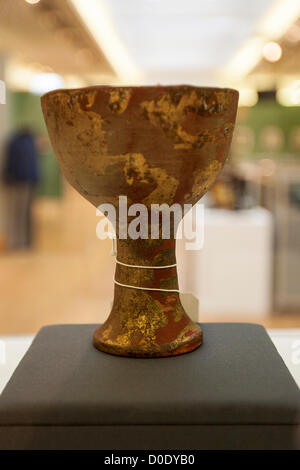 Auction at Christie's.  23/11/2012 , London, United Kingdom - A prop chalice, the clay cup painted in gilt and red and applied with plaster and mud to simulate distress, made for the 1989 Paramount Pictures/Lucasfilm production Indiana Jones And The Last Crusade   Credit:  Mario Mitsis / Alamy Live News. Stock Photo