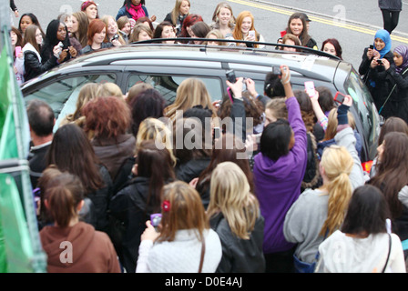 Fans mob a car X Factor finalists arrive at the ITV Studios London, England - 29.10.10 Stock Photo