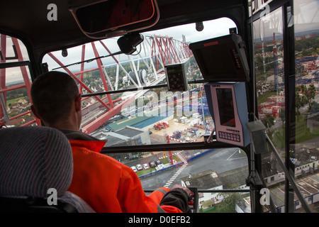 CRANE OPERATOR ON A CONSTRUCTION SITE AT THE CONTROLS OF HIS CRANE ARPAJON ESSONNE (91) FRANCE Stock Photo