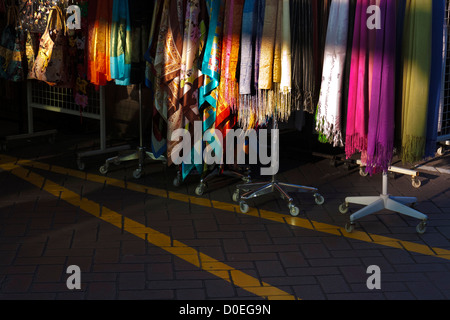 Head scarves and Muslim hijabs on a rack in Singapore's Chinatown. Stock Photo