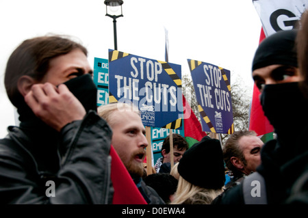 Education demonstration.A couple of students are masked and behind them are placards saying 'Stop the Cuts'. Stock Photo