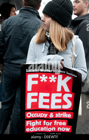 Demonstration organized by National Union of Students (NUS) against education cuts. A student holds a placard saying 'F**K Fees' Stock Photo