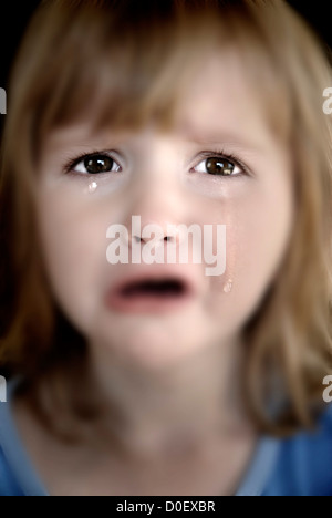 Portrait of little girl crying with tears rolling down her cheeks Stock Photo