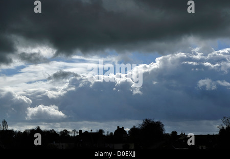 Dark heavy sky and rainy (stratocumulus), in may, above a village in northern Mayenne, Loire country, France. Stock Photo