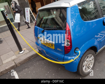 Electric car charging in street in London Stock Photo