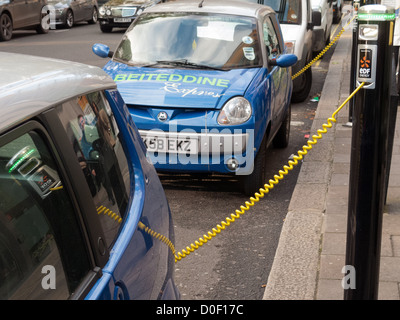 Electric car charging in street in London Stock Photo