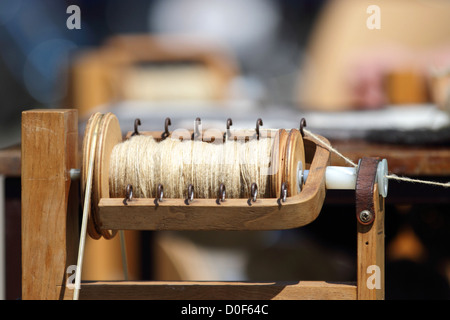 Close up of wool being spun on a spinning wheel. Stock Photo