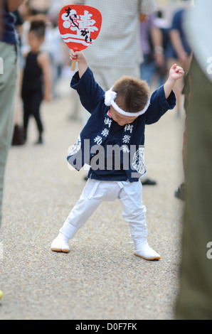 A small boy enjoying himself at the Kishiwada Danjiri festival in Osaka, Japan. Stock Photo