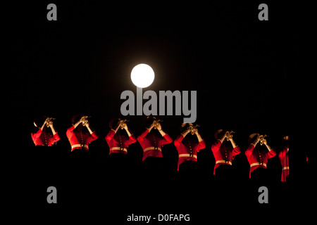 The moon shines bright as US Marine Drum & Bugle Corps buglers perform atop the ramparts during a Friday Evening Parade August 31, 2012 at Marine Barracks Washington. Stock Photo