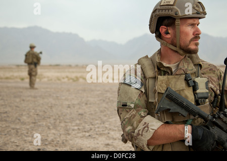 A US special forces soldier provides security during an Afghan National Security Force led patrol October 30, 2012 in Khak-E-Safed, Farah province, Afghanistan. Afghan forces have been taking the lead in security operations with coalition forces as mentors. Stock Photo