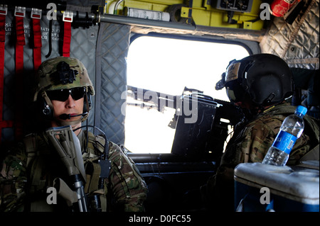 US Navy soldiers rides in a CH-47 Chinook helicopter during a mission September 26, 2012 to Pur Chaman district, Farah province, Afghanistan. The mission marks the first time coalition forces have been to the Pur Chaman district in over a year. Stock Photo
