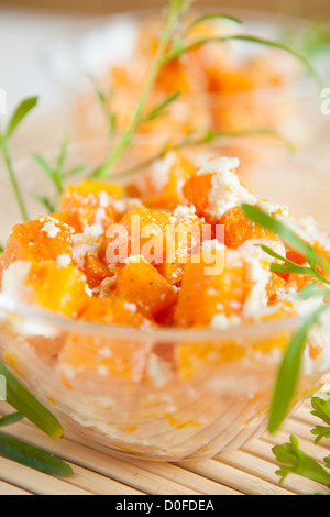 Baked pumpkin with cheese in clear glass bowls, close up Stock Photo