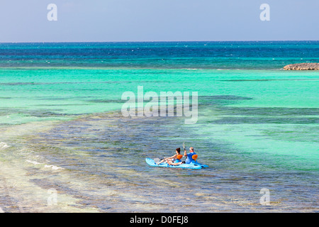 Kayakers explore along Bita Bay on Green Turtle Cay, Bahamas. Stock Photo