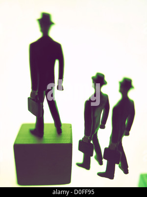 businessman with briefcase stepping up on a block above 2 men. miniature. ©mak Stock Photo