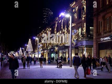 Buchanan Street Glasgow at night - November. Workers and shoppers under blue lights. Princes Square. Christmas lights. Scotland Stock Photo