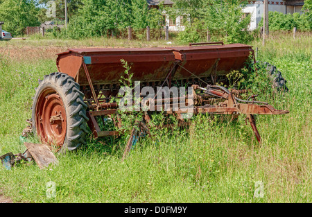 Old broken seeder in village. Stock Photo