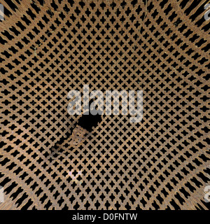 Rusty perforated metal surface. Worn iron grille distorted background texture. Stock Photo