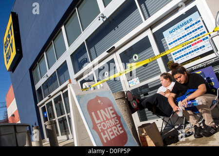 Shoppers lined up outside of a Best Buy store for Black Friday deals.  Stock Photo